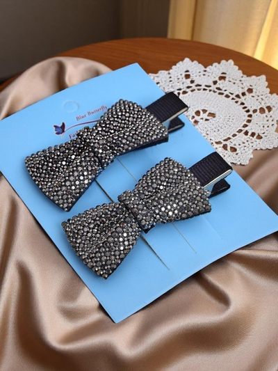 Royalfashion Set de 2 agrafe de păr cu fundițe și strasuri Isadora
