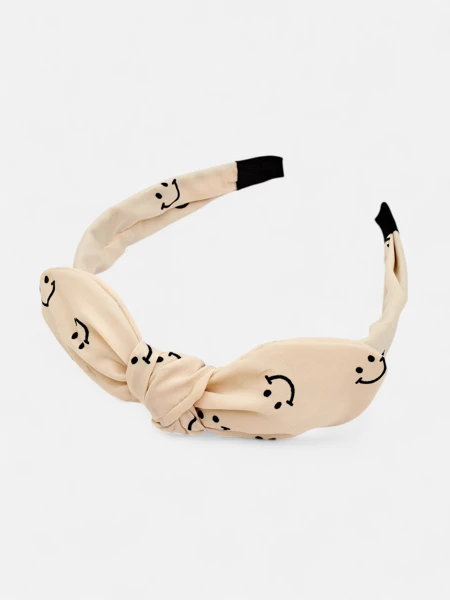 Royalfashion Bando pa cabellos de criaturas con un moñito con un diseño de caritas sonrientes
